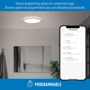 A smartphone shows settings for the Artika Macy 15 in. LED RGB Wifi light as it glows in a modern room. Text: PROGRAMMABLE.