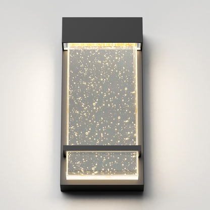 The Skyler indoor-outdoor LED wall light by Artika features a modern rectangular frame and a clear bubble-accented panel, illuminated by soft white LEDs.