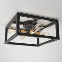 The Artika Princeton 4-light flush mount features a black rectangular metal frame with gold accents and four exposed bulbs on a central hub, adding a modern touch to any white ceiling.