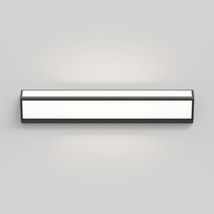 The Artika Preston LED modern bathroom vanity light 3 CCT features a black frame and frosted diffuser, mounted on a light gray wall, providing a soft, even glow.