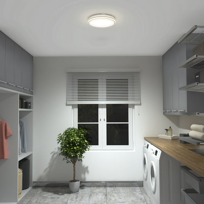 A modern laundry room with gray cabinets, a washing machine and dryer, a wooden countertop with towels, a potted plant on the floor, and a window with white blinds under a round ceiling light.