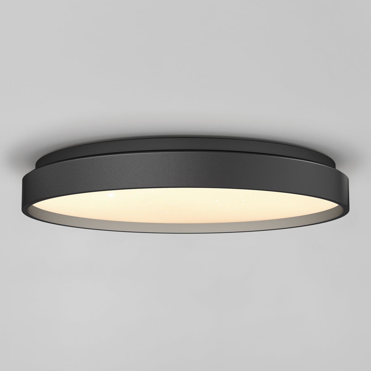 The Artika Celestia 15 in. modern LED flush mount light with remote is installed on a smooth gray ceiling, offering a stylish black finish and soft glowing illumination.