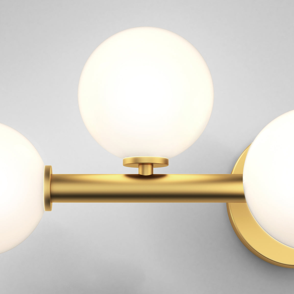 The Artika Bloom 27-in (69 cm) 3-Light Modern LED Vanity Light features a gold metal base and three frosted glass globes, ideal for chic bathroom lighting. Pictured against a plain light grey background.