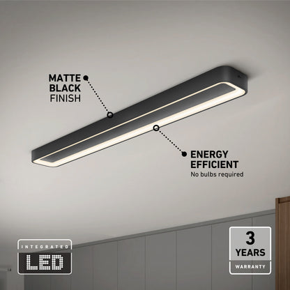 The Artika Aiden 48 in. LED modern flush mount light 5 CCT, with a matte black finish and energy-efficient integrated LED, is mounted on a white ceiling above gray cabinets and comes with a 3-year warranty.