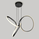 A modern, black LED pendant light with two intertwined, looping rings hanging from a round ceiling mount by three cords, set against a plain gray background.