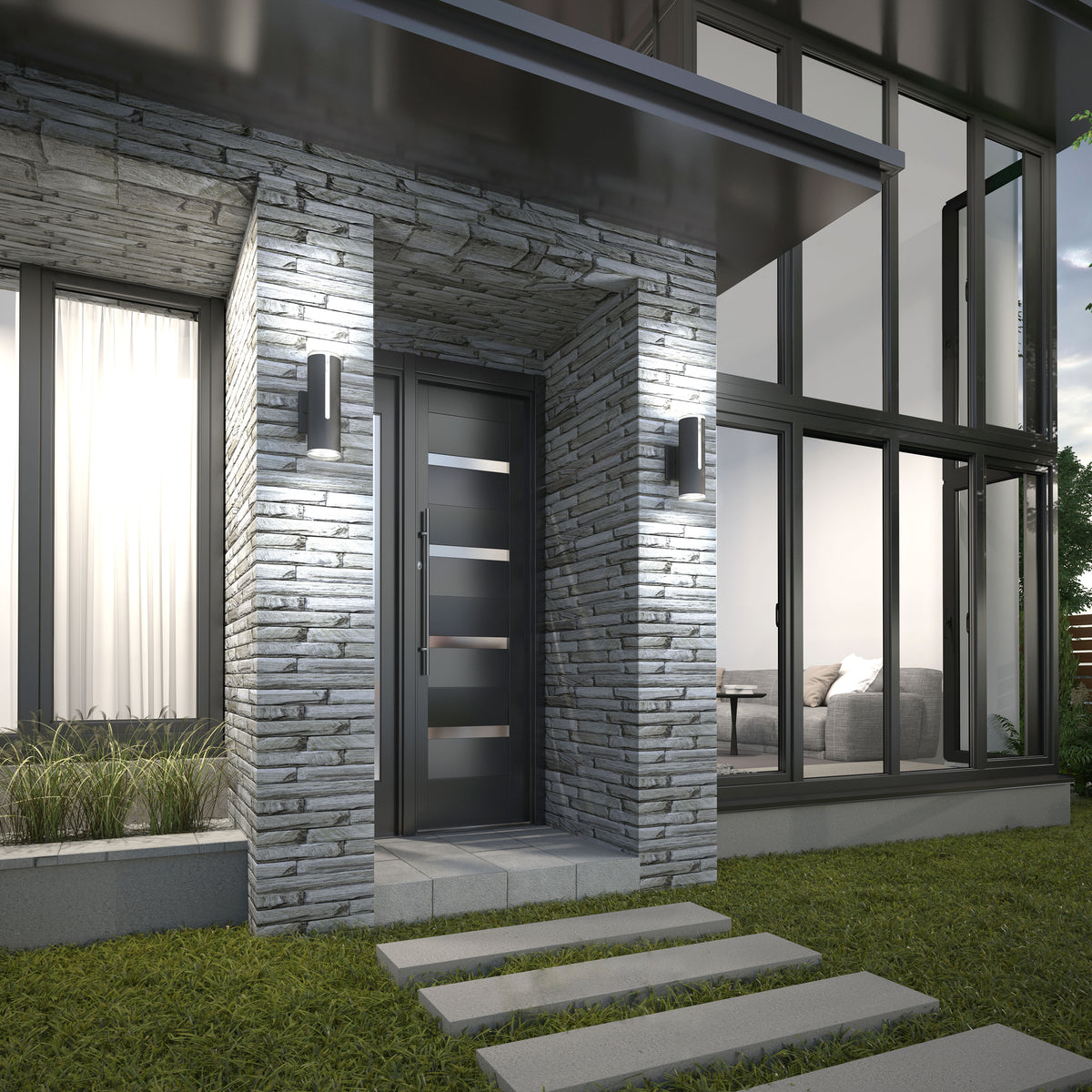 Modern house entry with a dark door featuring horizontal glass panels, surrounded by textured gray stone. Large windows reveal a bright interior with a couch. Concrete stepping stones lead through a grassy lawn.