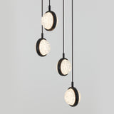Four modern pendant lights with round, textured glass shades and black frames hang at different heights against a plain light gray background.