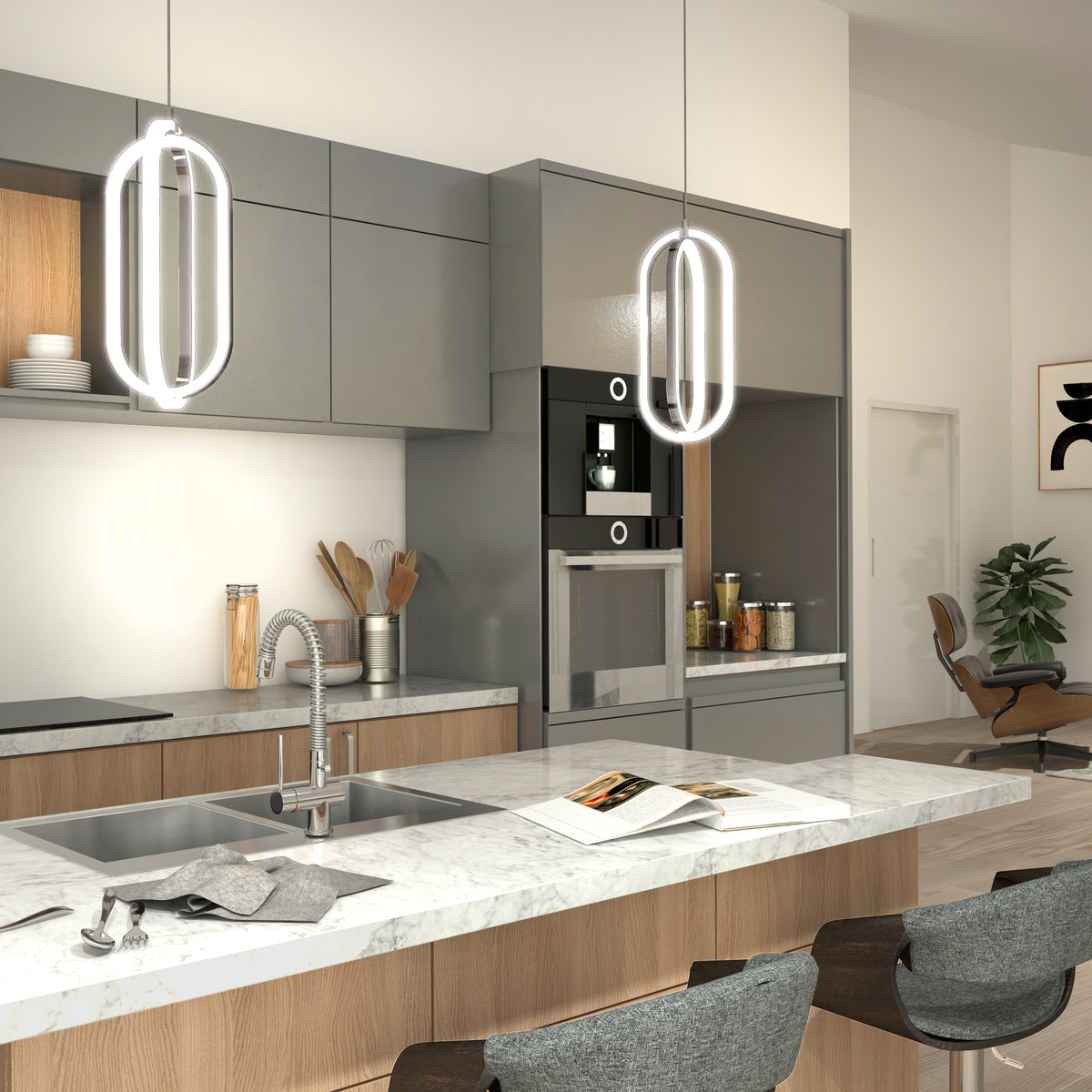 Modern kitchen features marble countertops, gray and wood cabinetry, built-in oven, and two Artika Arlo 1-light LED pendants. Open shelves hold jars; the island has a sink and stools, with a lounge chair and plant in the background.