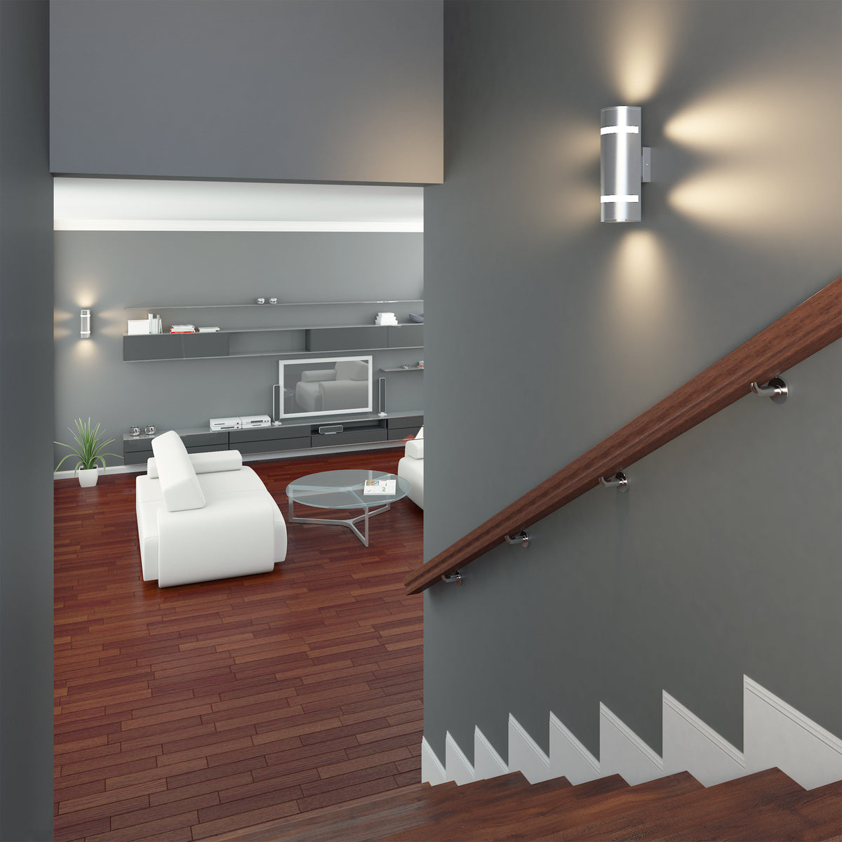 A modern living room with white furniture, wood floors, gray walls, and built-in shelving, viewed from a staircase with a wooden handrail and Artikas Q1 indoor-outdoor wall light providing contemporary illumination.