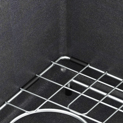 Close-up of the Artika Baycrest 33 in. black double bowl kitchen sink installed in a textured dark countertop.
