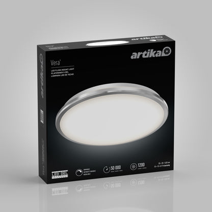 A box of Artika Vera 13 in. LED modern flush mount light shows a large image of the round chrome fixture. The packaging highlights its 50,000-hour lifespan, 1200 lumens brightness, dimmable settings, and sleek modern design.