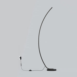 The Artika Arc LED Floor Lamp features a minimalist, modern design with a thin curved black stem on a round base. It plugs into a wall outlet with a visible black cord and foot switch, all set against a light gray background.