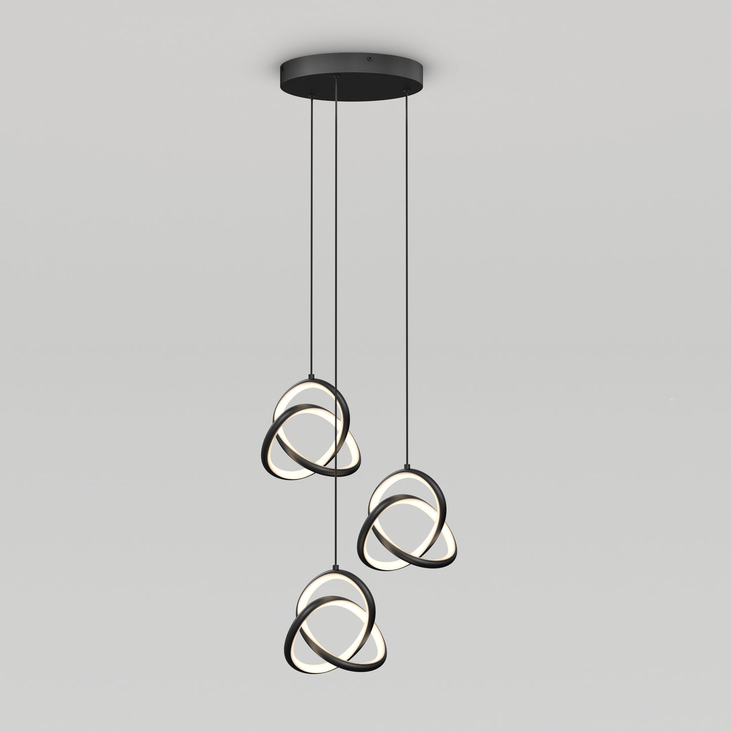 The Artika Zephyr 3-light LED pendant features three black rings with illuminated inner edges, intertwined and suspended from a round black ceiling mount by cords for a modern look.