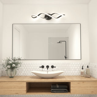 A modern bathroom features a large rectangular mirror, white hex tile backsplash, wood vanity, vessel sink, black fixtures, glass shower, and the Artika Swirl LED bathroom vanity light above the mirror.