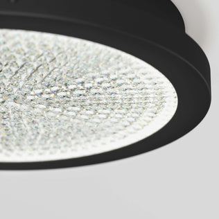 Close-up of Artika’s Glitter 14 in. LED Flush Mount Ceiling Light with a crystal-textured surface and black frame against a light background.