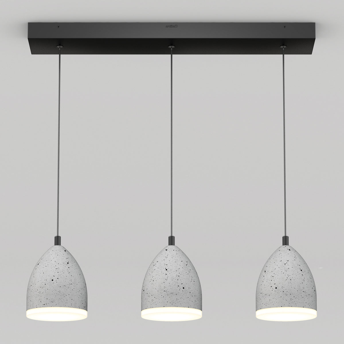 Three modern pendant lights with gray, speckled, dome-shaped shades hang in a row from a rectangular black ceiling mount against a plain white background. The lights are evenly spaced and turned on.