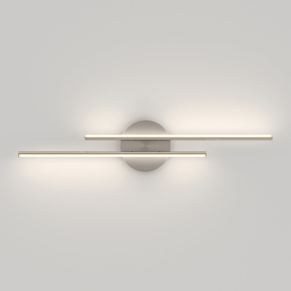 Minimalist wall light fixture with two horizontal, parallel LED light bars mounted on a round metallic base, casting soft, even illumination on a plain white wall.