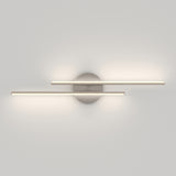 Minimalist wall light fixture with two horizontal, parallel LED light bars mounted on a round metallic base, casting soft, even illumination on a plain white wall.