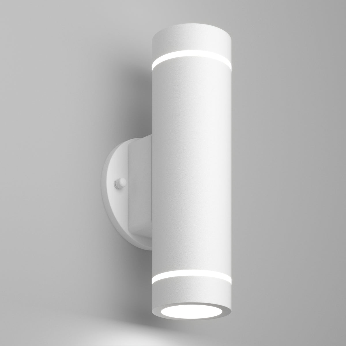 The Artika C7 indoor-outdoor LED wall light 3 CCT is a modern, cylindrical white sconce with a minimalist design that mounts vertically and emits light from both the top and bottom.