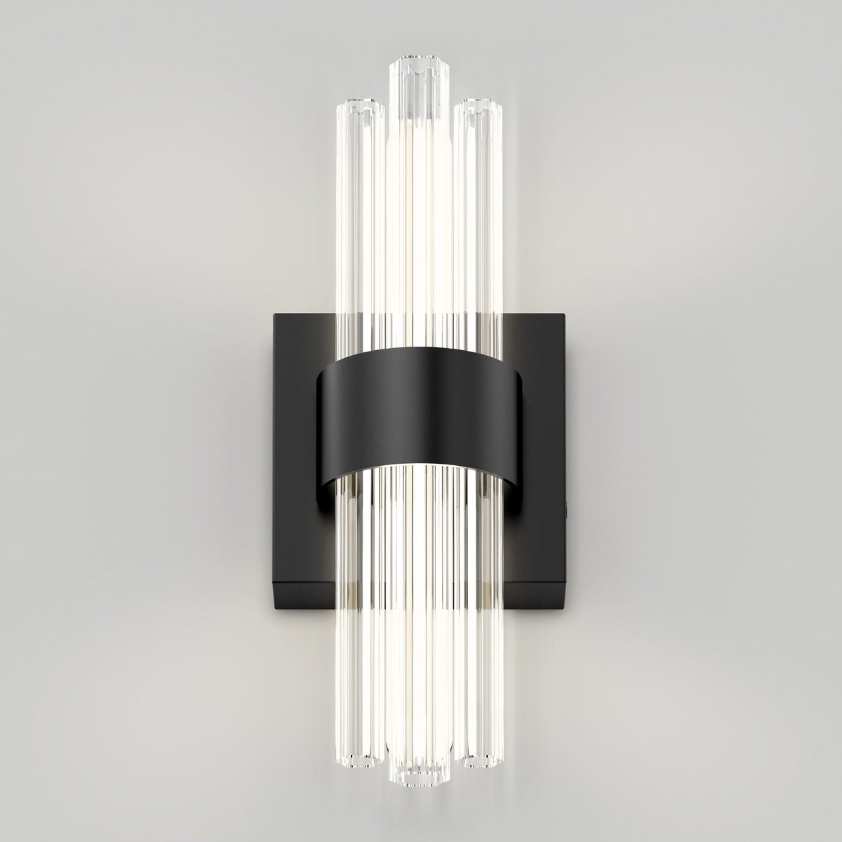 A modern wall sconce with vertical glass rods emitting light, mounted on a matte black rectangular backplate with a central black band securing the rods.