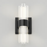 A modern wall sconce with vertical glass rods emitting light, mounted on a matte black rectangular backplate with a central black band securing the rods.