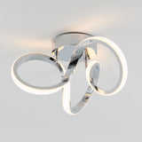 Modern ceiling light fixture with three interlocking chrome loops, each lined with an integrated LED strip, mounted on a round chrome base against a white ceiling.