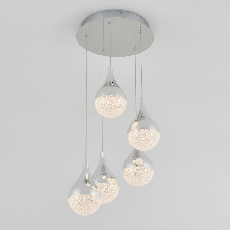 The Artika Glitzer 5-light LED pendant features five teardrop-shaped lights with silver tops and textured illuminated bottoms, each hanging at varying lengths from a round silver base for a modern ceiling accent.