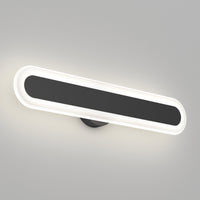 The Artika Pista modern LED bathroom vanity light 5 CCT is a matte black, wall-mounted, oval fixture with a black central panel and glowing white border, offering dimmable lighting for a sleek look on a light gray wall.