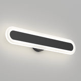 A modern, oval-shaped wall light with a black center and glowing white edges, mounted on a light gray wall. The design is sleek and minimalist.