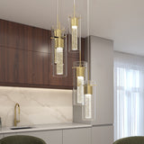 Modern kitchen with wood cabinets and a light-colored marble backsplash. Four cylindrical pendant lights with gold accents and bubble glass hang over a countertop, creating an elegant and contemporary ambiance.