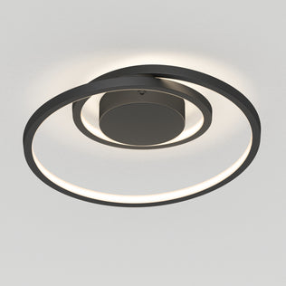 The Artika Salto LED flush mount light features two concentric circular rings and emits a soft white glow, creating a modern look when mounted on a light-colored ceiling.