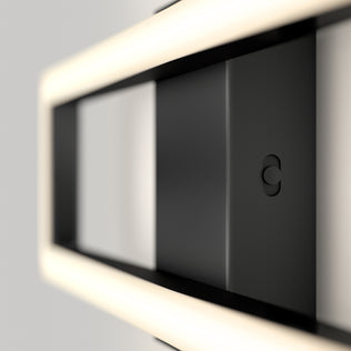 A close-up of the Artika Dover 27-in Integrated LED 5-CCT Vanity Light Bar shows its modern, minimal design with glowing rectangular edges, a matte finish, and a small circular button—perfect for any contemporary bathroom.