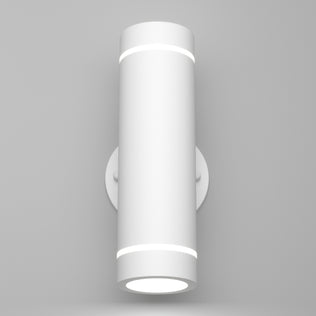 The Artika C7 indoor-outdoor LED wall light 3 CCT is a modern cylindrical white sconce with subtle circular bands, mounted on a round base against a plain light gray wall.