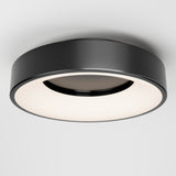 A modern, round black ceiling light fixture with a wide, flat design and a glowing white diffuser, mounted on a plain white ceiling.