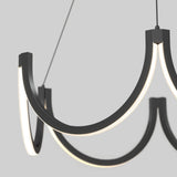 Modern chandelier with three curved, black metal arms, each featuring integrated LED lights along the inner edge, suspended by thin cables against a plain light gray background.