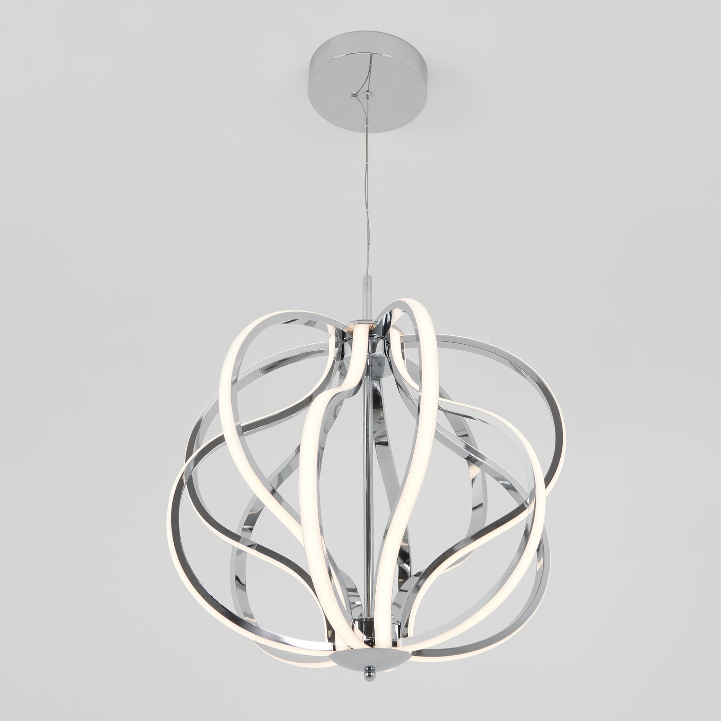 The Meridian LED pendant light by Artika features curved chrome metal bands creating an open sphere, with integrated LED strips for a soft white glow. Suspended from a round ceiling mount, it brings modern style to any space.