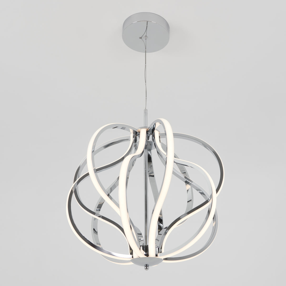 The Artika Meridian LED pendant light features curved chrome strips and integrated LEDs in an abstract, spherical design. Suspended by a thin cord from a round chrome ceiling mount, it brings contemporary style to any space.