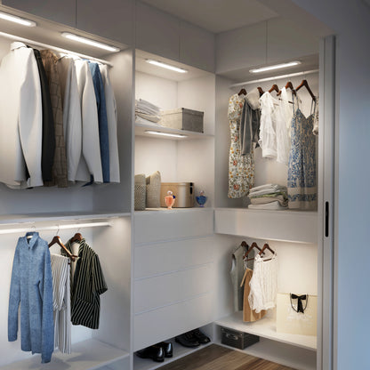 Modern walk-in closet with clothes, shelves, handbags, and soft Impulse Under-Cabinet LED Light RGB+CCT by Artika.