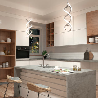 Modern kitchen with white cabinets, wooden accents, and a gray island with two wooden stools. Two Artika DNA LED pendant lights hang above the island, and a window above the sink lets in natural light.