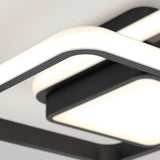 Close-up of a modern ceiling light fixture with sleek, black-frame and integrated white LED panels, featuring smooth curves and a minimalist design.