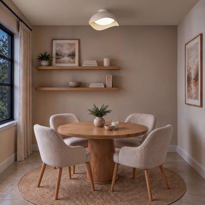 An Artika Adara 15 in. Modern LED Flush Mount Ceiling Light 5 CCT centered above a round wooden dining table with four upholstered chairs.