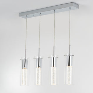 The Artika Bubble Flow 4-light pendant features four cylindrical glass lights with illuminated inner tubes, suspended from a rectangular chrome base against a plain white ceiling.