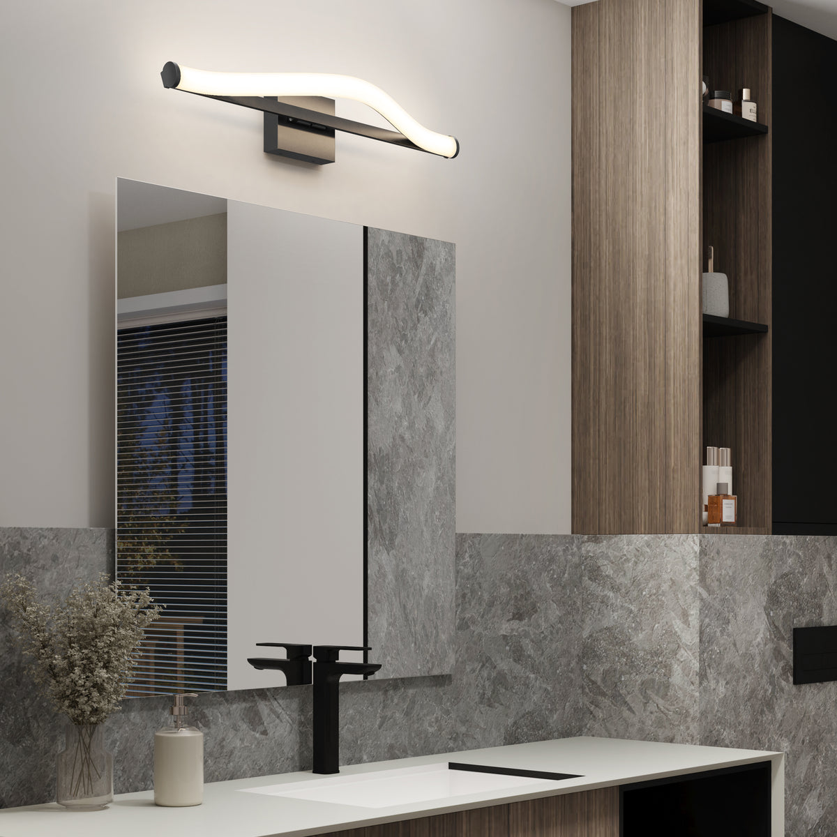 Modern bathroom with a sleek rectangular mirror, a black faucet, a light fixture with a wavy design above the mirror, wood and stone-textured walls, and shelves with various toiletries.