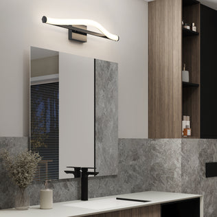 Modern bathroom with large mirror, Artika Arc 27-in LED vanity light bar above, black faucet, marble walls, and wooden shelves.