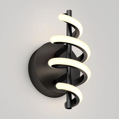 The Artika Chorus LED Wall Light features a black circular base and vertical rod wrapped with two spiral LED tubes, emitting a soft white glow, shown mounted on a light gray wall.