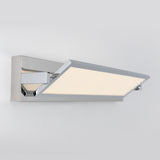 A modern, rectangular wall-mounted LED light fixture with a chrome finish and a flat, angled panel emitting soft white light, set against a plain light gray background.