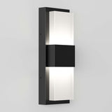 A modern wall-mounted light fixture with a rectangular black base and two frosted glass panels that emit light from both the top and bottom. The design is sleek and minimalistic against a light gray wall.