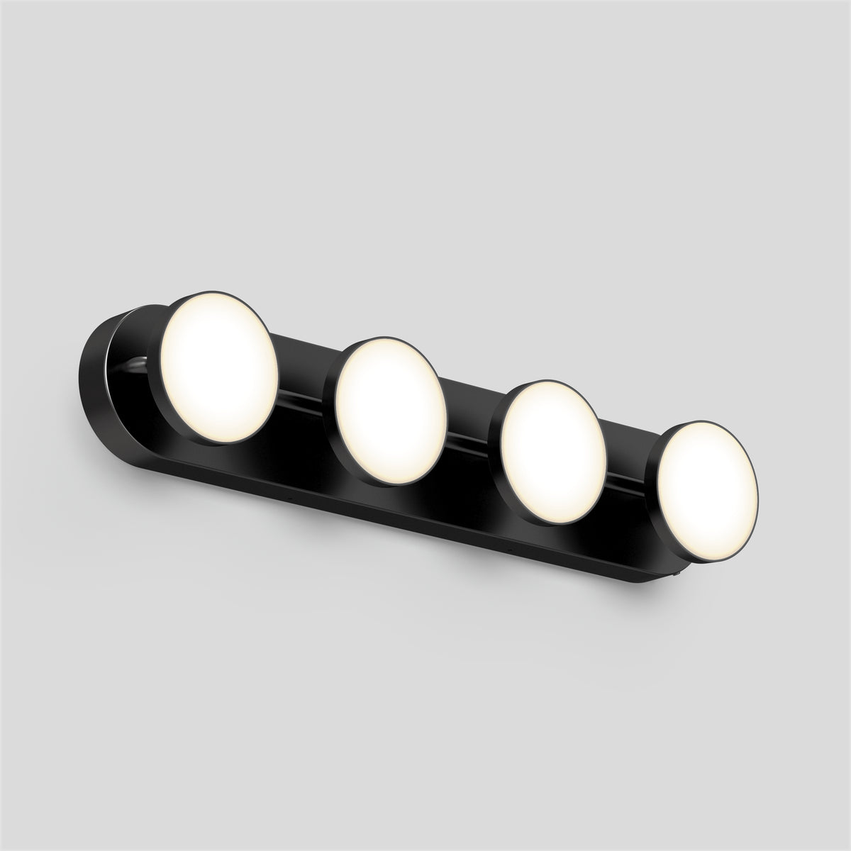 A sleek black wall-mounted light fixture with four evenly spaced round, illuminated bulbs against a plain light gray background.
