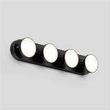 A sleek black wall-mounted light fixture with four evenly spaced round, illuminated bulbs against a plain light gray background.