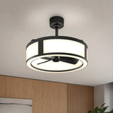 Modern ceiling fan with a circular, drum-shaped light fixture and black frame, mounted on a white ceiling in a contemporary room with wooden wall panels and a glimpse of a plant.
